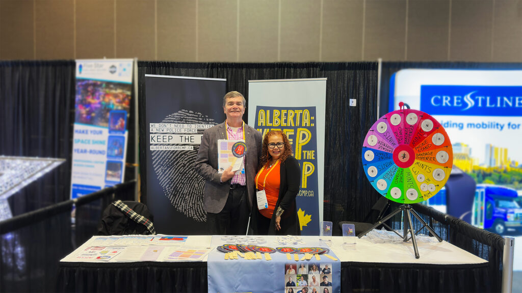 Oneil Carlier and Isabel Betancourt at the USJE tradeshow booth advocating for Alberta RCMP